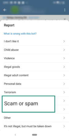 Phone screen showing the option for reporting Scam or Spam on Telegram.